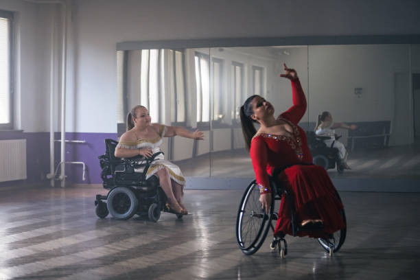 istock Two women with a disability, wheelchair dancers practicing dance performance 2202362280