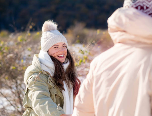 husband and wife on the mountain holding hands looking at each other happy enjoying together