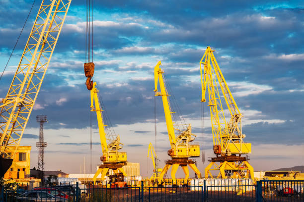 istock Cargo port in Burgas during sunset showcasing yellow cranes and dynamic sky. 2202370827