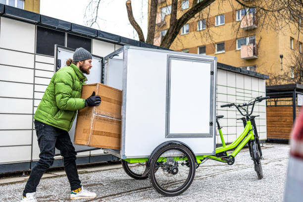 istock Cargo bike courier making a delivery to a parcel locker 2202375977