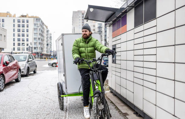 istock Cargo bike courier making a delivery to a parcel locker 2202375978