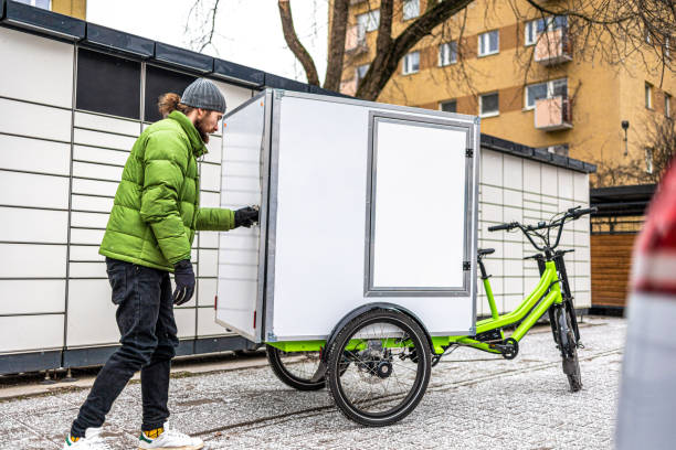 istock Cargo bike courier making a delivery to a parcel locker 2202375980