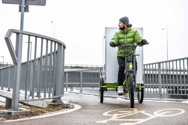 istock Bicycle courier delivering parcels in the city on a cargo bike 2202375986