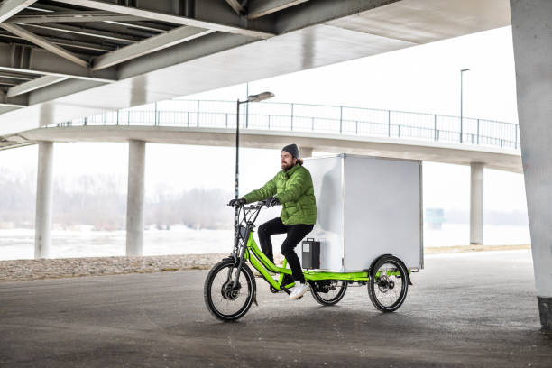 istock Bicycle courier delivering parcels in the city on a cargo bike 2202375995