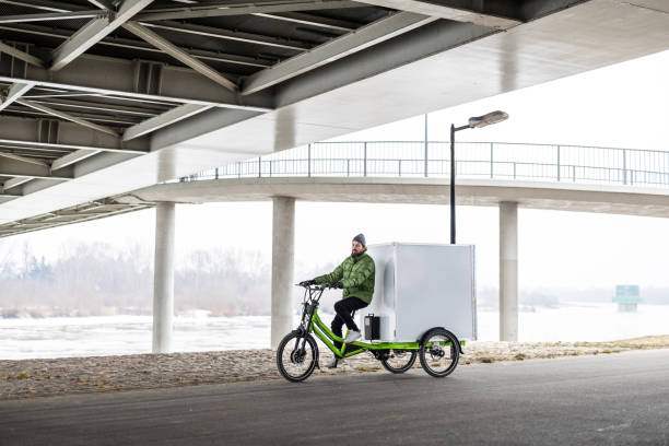 istock Bicycle courier delivering parcels in the city on a cargo bike 2202375997