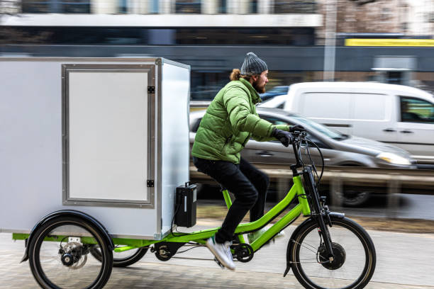 istock Bicycle courier delivering parcels in the city on a cargo bike 2202376004
