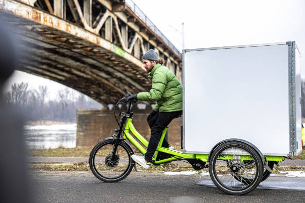 istock Bicycle courier delivering parcels in the city on a cargo bike 2202376008