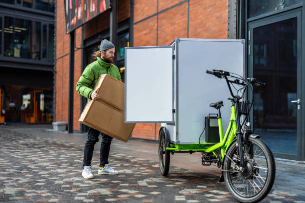 istock Bicycle courier delivering parcels on a cargo bike in the city 2202376009