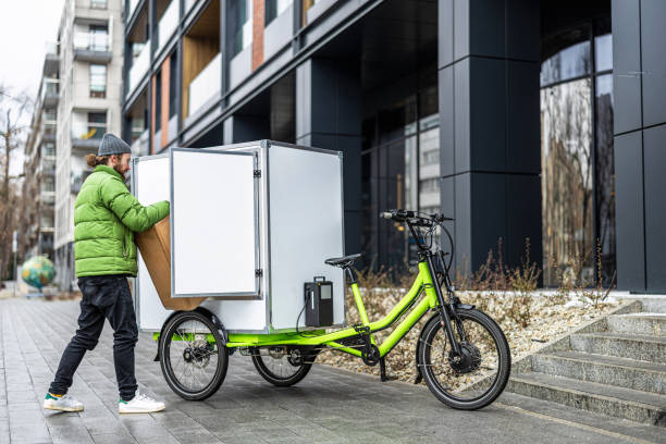 istock Bicycle courier delivering parcels on a cargo bike in the city 2202376010