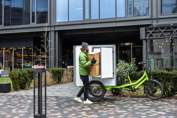 istock Bicycle courier delivering parcels on a cargo bike in the city 2202376016