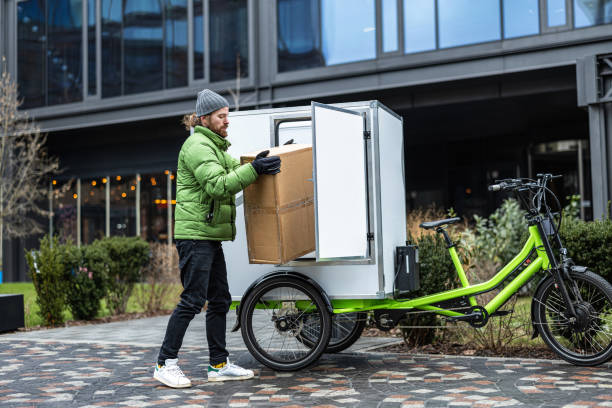 istock Bicycle courier delivering parcels on a cargo bike in the city 2202376020