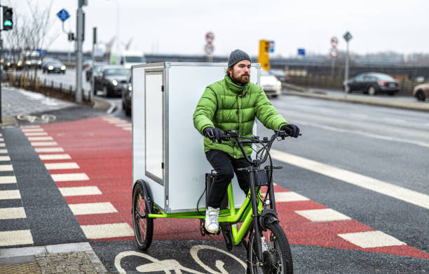 istock Bicycle courier delivering parcels in the city on a cargo bike 2202376024