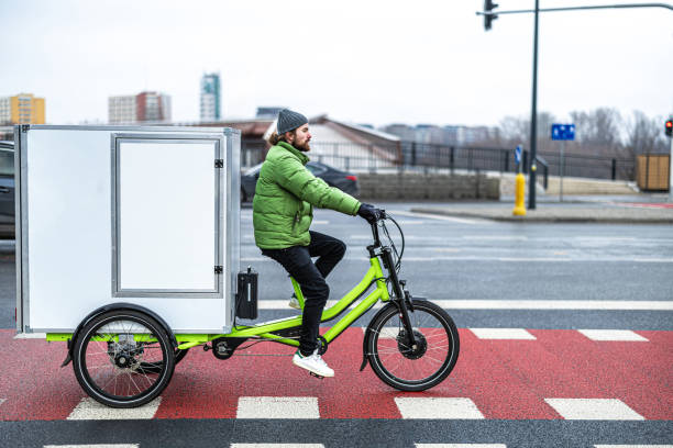 istock Bicycle courier delivering parcels in the city on a cargo bike 2202376027