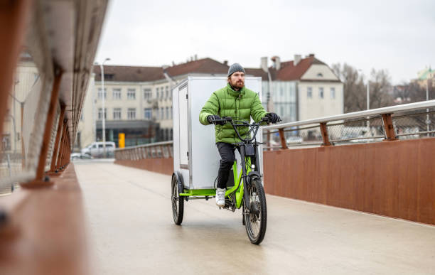 istock Bicycle courier delivering parcels in the city on a cargo bike 2202376032