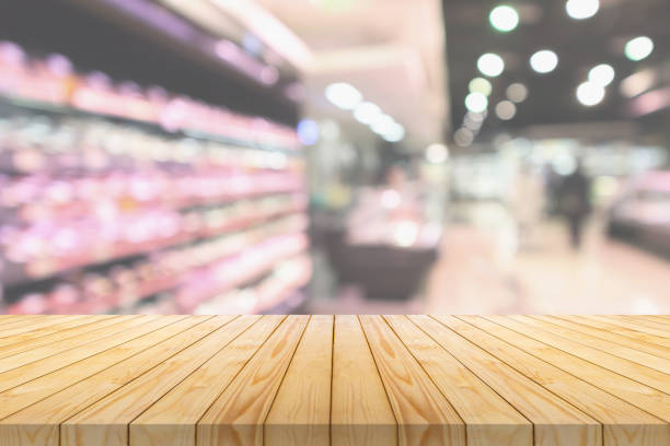 istock Empty wood table top with supermarket blurred background for product display 2202379910