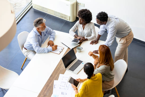 istock Diverse Business Team Collaborating on Project at Modern Office 2202380560