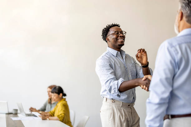 istock Friendly Business Meeting with Handshake and Team Collaboration 2202380584