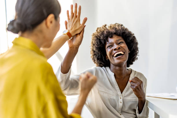 istock Joyful Women Celebrating Success With a High Five 2202380710