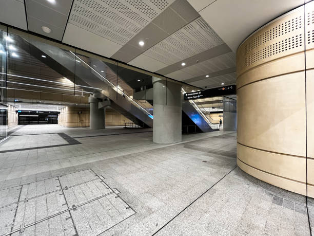 istock A sleek and modern underground metro station featuring sandstone walls, concrete columns, and polished floors 2202380841