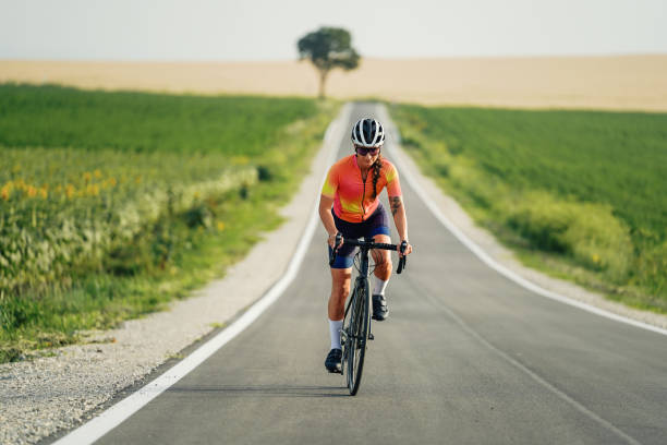 istock A solo female cyclist enjoys a peaceful ride on an empty road. 2202381634