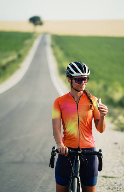 istock Recharging with a protein bar while road cycling. 2202381650