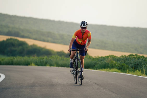 istock A solo female cyclist enjoys a peaceful ride on an empty road. 2202381656