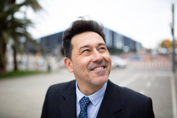 istock Handsome mature businessman looking away standing outside 2202381754