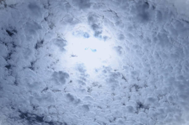Sun trying to break through Altocumulus clouds