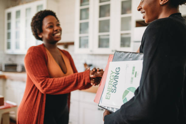 A personal advisor is shaking hand with a customer at home