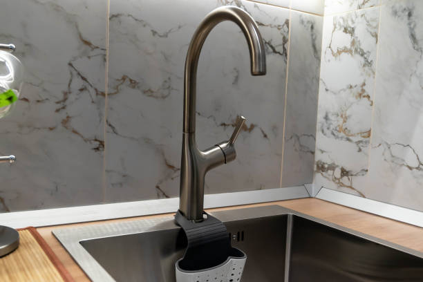 istock Modern kitchen faucet with sponge holder and marble tile backsplash 2202397671