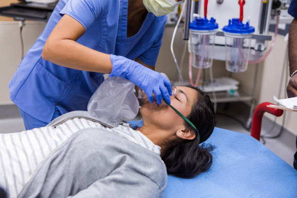 istock Emergency Medical Assistance: Nurse Administering Oxygen Mask 2202397828
