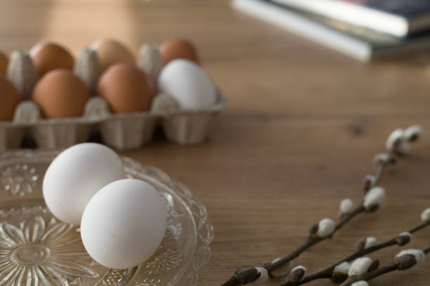 Fresh farm eggs in carton box on wooden table. Eggs in egg boxes