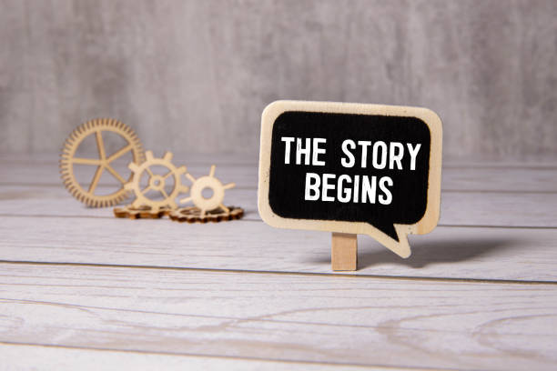 istock Text STORY BEGINS 2024 on tablet display in businessman hands on the white background. 2202397935