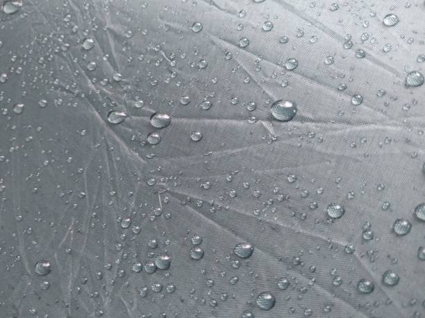 istock Raindrops on the surface of the umbrella 2202403238