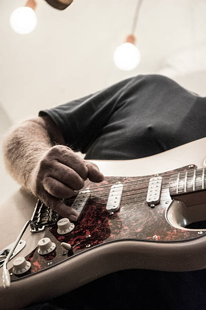 istock Desaturated Electric Guitarist Playing 2202403458