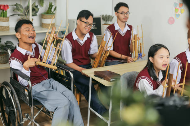 istock Group Of Students With Disabilities Learning Traditional Music At The Classroom 2202405847