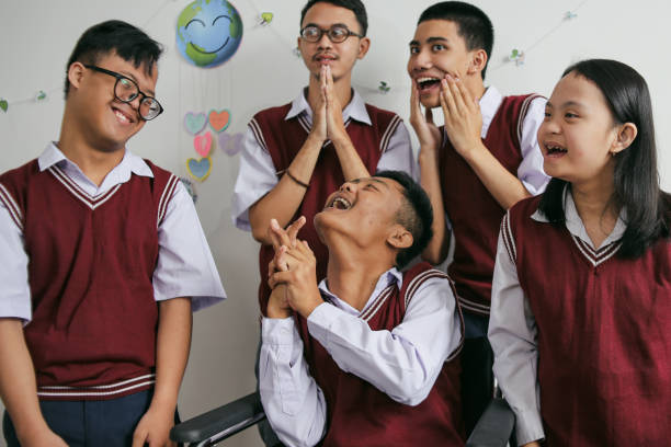 Portrait Of Cheerful Students With Disabilities Having Fun Together At The Classroom