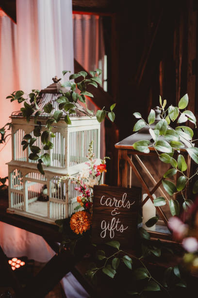 Cards and gifts table at wedding reception with flowers and antique birdcage