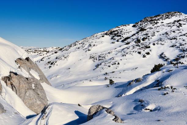 istock Snowy mountain landscape under clear blue sky 2202415531