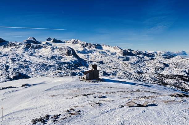 istock Snowy mountain landscape with cabin 2202415554