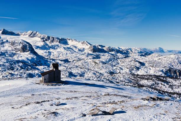 istock Solitary cabin in snowy mountain landscape 2202415614