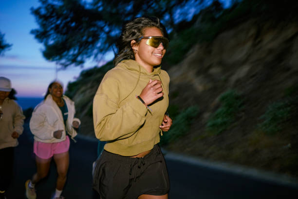Group of Gen Z runners, running together at night