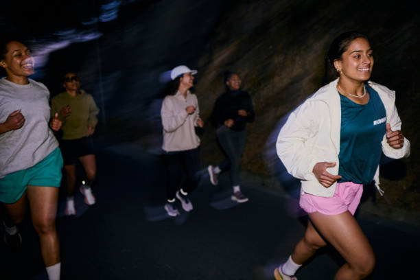 Group of Gen Z runners, running together at night