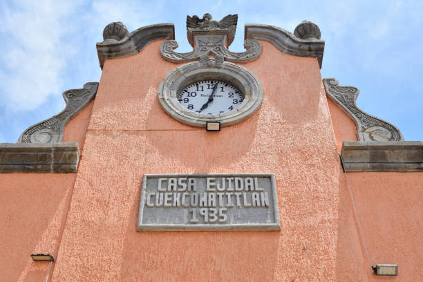 Close-up of the historic clock on the facade of Casa Ejidal in Cuexcomatitlan, Jalisco, built in 1935, showing its architectural details