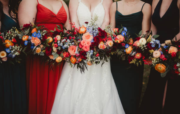 istock Bride and bridesmaids in bright multi-colored dresses and bouquets 2202424136