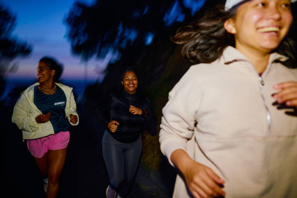 istock Group of Gen Z runners, running together at night 2202425063