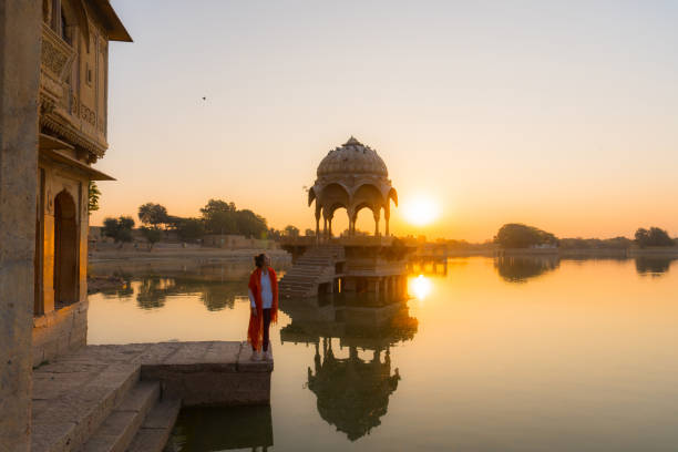 istock Woman at Gadisar Lake  in Jaisalmer looking at sunrise 2202425882