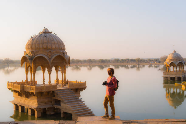 istock Man with camera walking near Gadisar lake in Jaisalmer looking at view 2202425962