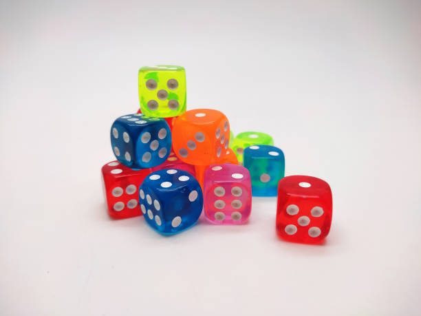 istock Colorful Transparent Dice Stacked on a White Background 2202429034