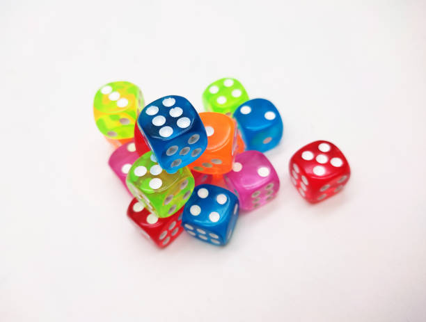 istock Colorful Transparent Dice Stacked on a White Background 2202429036